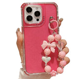 iPhone 16 Pro Max Glitter stødsikkert hybrid cover med håndledsrem - Hot Pink